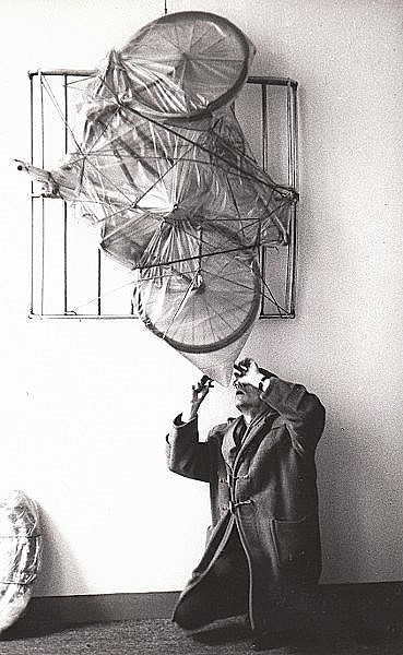 Christo while preparing his exhibition in 1964 at Gallery Ad Libitum